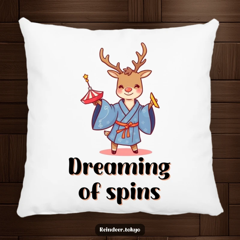 Funny pillow featuring a smiling reindeer in a blue kimono, twirling a spinning top, adding cozy and playful vibes to decor.