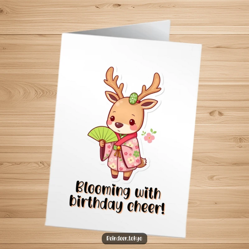 Funny free printable birthday card showing a reindeer dressed in a floral kimono, holding a green fan.